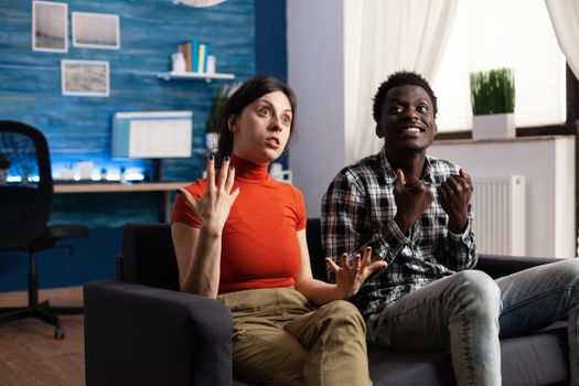 Angry diverse couple reacting inappropriately over unhealthy conflict