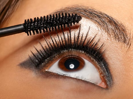 Luscious lashes. Closeup shot of a woman applying mascara to her eyelashes.
