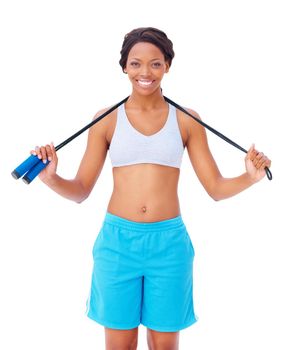 Skipping offers great cardio. Pretty young african american woman holding a skipping rope around her neck against a white background.