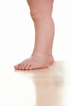 Cropped view of a toddlers legs.
