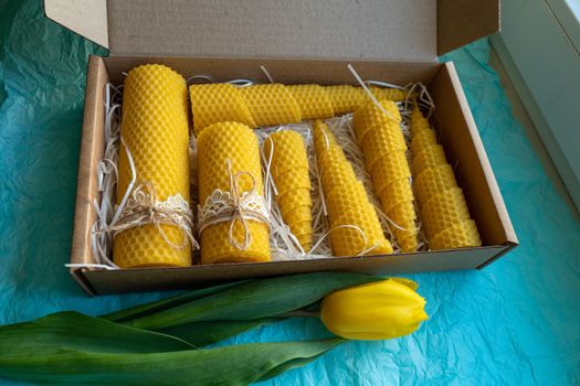 Seven beeswax candles in a box. The candles are decorated with lace and tied with a jute rope.
