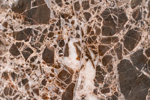 Luxurious dark brown marble with light streaks. The polished quartz stone background is naturally striped with a unique pattern, dark concentric stripes