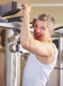 He loves gyming. Portrait of an excited man working out at the gym.