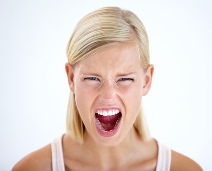 RAGE. Head and shoulders portrait of a furious woman screaming loudly.