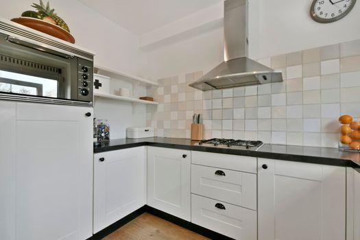 Small kitchen with white furniture