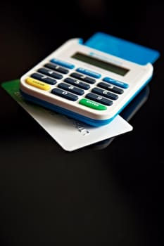Calculating your credit. A credit card underneath a calculator.