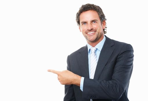 Business man pointing with finger. Portrait of smart mature business man pointing sideways on white background.