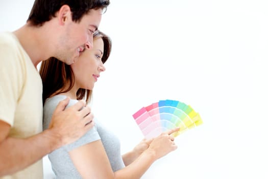 What colour would you pick - Copyspace. Over the shoulder image of a young couple picking a colour for their bedroom - Copyspace.