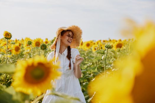 woman with two pigtails looking in the sunflower field countryside. High quality photo
