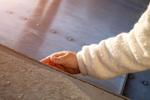 baby hand touch beton on sidewalk close up