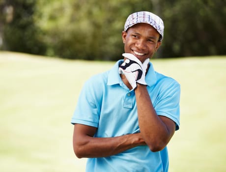 Pleased with his game. Shot of a positive-looking african american golf pro.