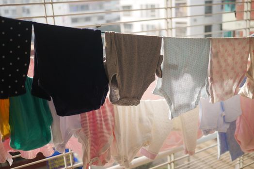 child clothes line filled with hanging trousers