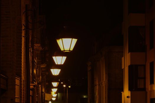 The vintage lamps shine on the street at night