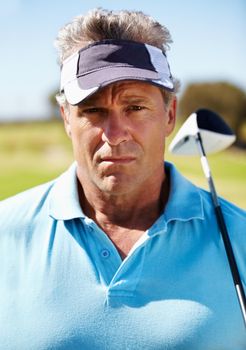 Serious about golf. Head and shoulders portrait of a mature golfer with his club over his shoulder.