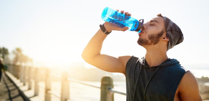 Water is the most important nutrient for active people. Shot of a sporty young man drinking water while exercising outdoors.