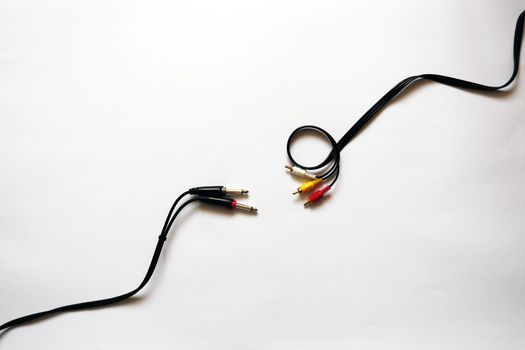 Photo on a white isolated background showing two cables for sound recording. Cord Jack 6.3 mm and RCA jack. You can use this photo as a background for projects related to audio recording, audio connection or a store with cords and cables. High quality photo