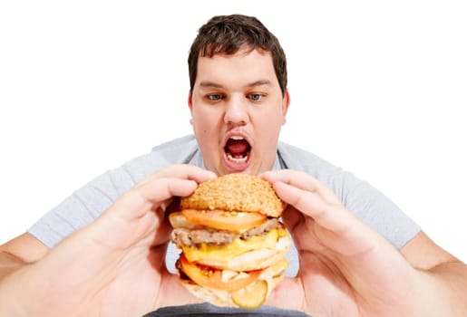 Get in my belly, burger. An obese young man about to eat a huge hamburger.