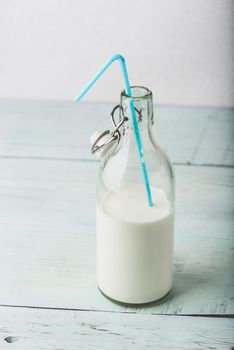 Bottle of milk with blue straw