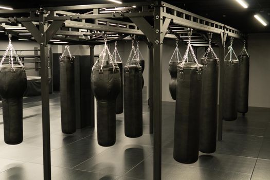bag punching boxing background indoors, from competition fitness in gym from bags heavy, kickboxing club. Leather activity dark, aggression