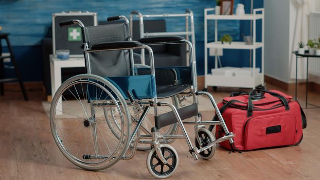 Empty nursing home room with wheelchair and medical equipment