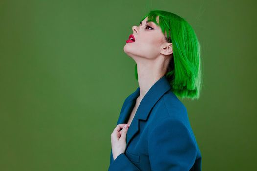 Young woman fun gesture hands green hair fashion studio model unaltered. High quality photo