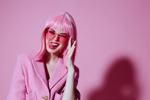 Portrait of a young woman gesturing with hands pink jacket lifestyle glamor pink background unaltered