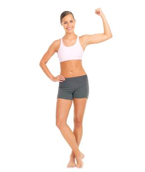 Check out these guns. Full length studio portrait of a young woman flexing her bicep against a white background.