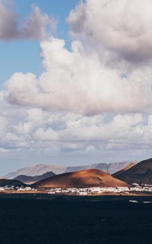 Amazing panoramic landscape of volcano craters in Timanfaya national park. Popular touristic attraction in Lanzarote island, Canary islans, Spain. Artistic picture. Beauty world. Travel concept.