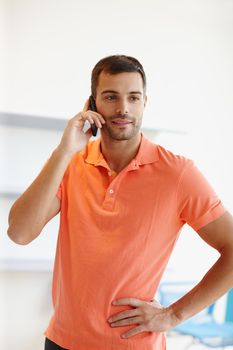 Taking a quick call. A casual young businessman taking a phone call.