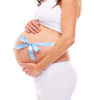 Shes expecting. Cropped shot of a pregnant woman isolated on white.