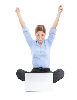 Better than ever before. Studio shot of a young businesswoman using her laptop on the floor and cheering in success against a white background.