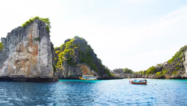 Cliffs of paradise. Panoramic view of beautiful islands with rocky cliffs, boats passing by - Copyspace.