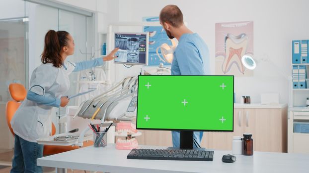 Dental cabinet with horizontal green screen on monitor. Modern dentist office with tools for teethcare and mockup isolated background. Stomatological equipment for oral care and dentition
