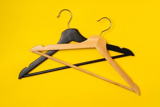 Hanger on colored paper background. Minimalistic fashion concept. Top view