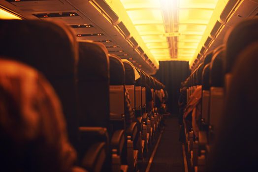 Time to jet off and explore the world. Shot of passenger seating inside an airplane.