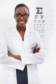 How clearly can you see. Portrait of a female optometrist standing beside a eye test chart.
