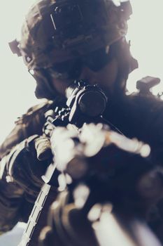 Close up photo of bearded soldier in uniform of special forces in a dangerous military action in a dangerous enemy area. Selective focus
