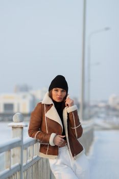 Trendy brunette in stylish winter jacket