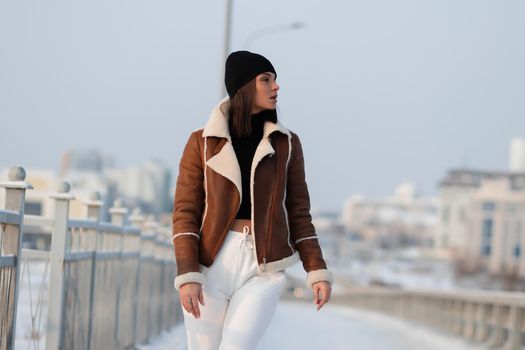 Trendy brunette in stylish winter jacket