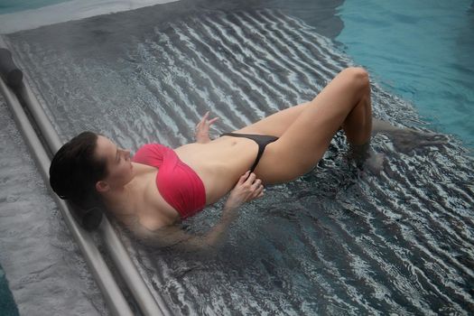 Seductive female resting in pool