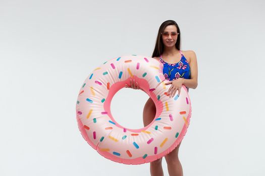 Seductive woman in swimwear with inflatable ring