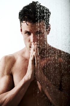 Cleansing his body and his mind. Shot of a handsome man taking a shower.