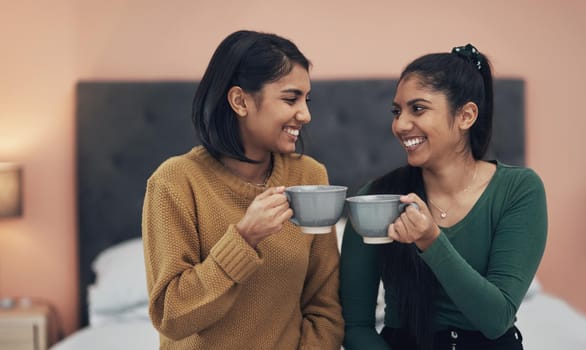 Theres no one else Id rather spill some tea with. Shot of two young women drinking coffee while sitting together at home.