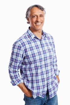 Smart business man smiling. Portrait of casually dressed mature business man smiling over white background with hands in pockets.
