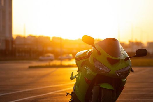 Cool man on motorcycle against sundown sky