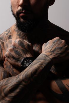 Muscular shirtless tattooed guy in studio