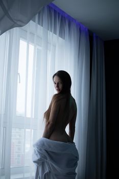 Topless sensual woman at home