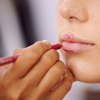 The outline of a perfect pout. Cropped shot of a woman applying colour to the outline of her lips.