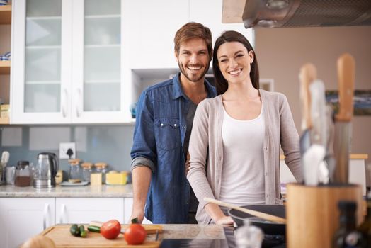 Bonding over date night. A young couple making dinner together at home.