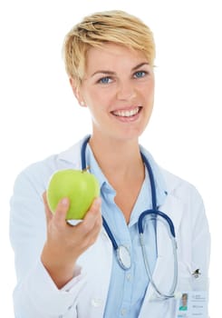 Offering you the chance at a healthier life. A young smiling doctor holding a green apple.